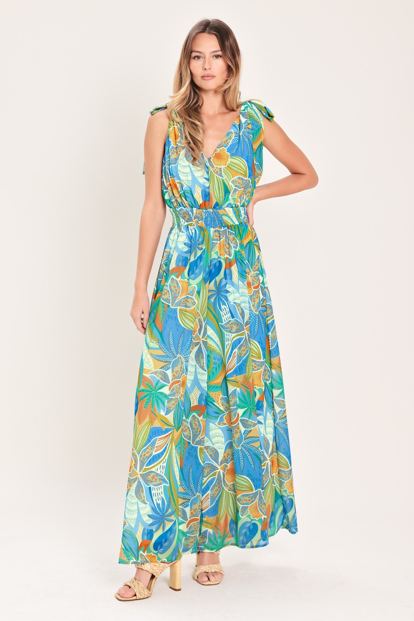 Woman wearing a colorful floral dress on a white background